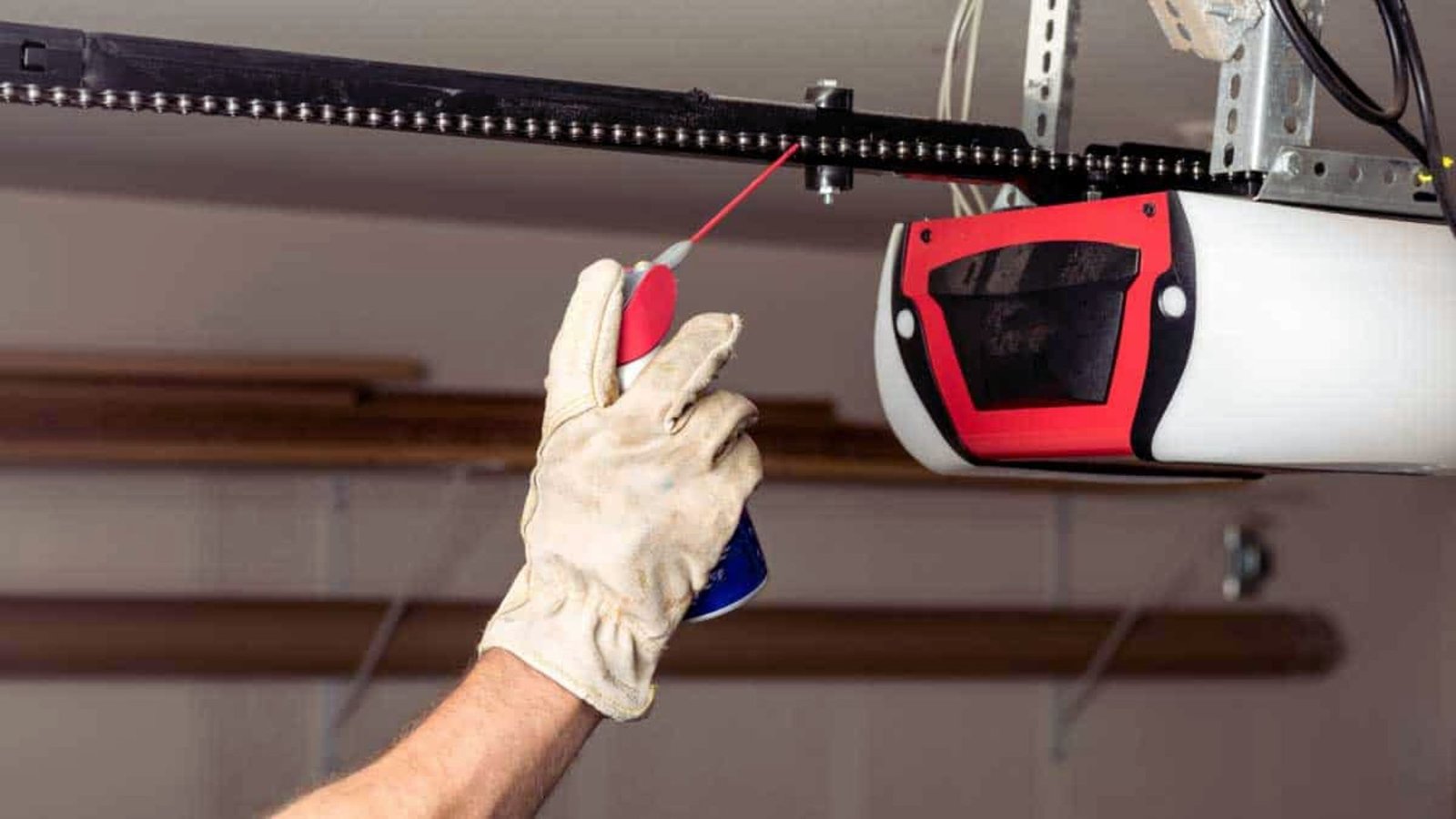 A technician repairing a garage door in Maryland, showcasing tools and parts used for the service.
